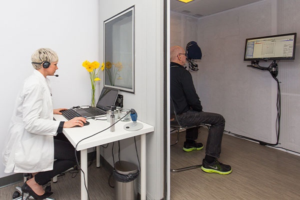 Patient in a hearing booth getting a  hearing screening test at Blue Sky Hearing.