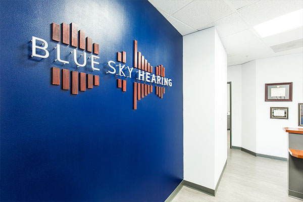 Blue Sky Hearing Logo on wall of office.