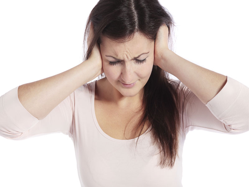 Image of a woman holding her ears